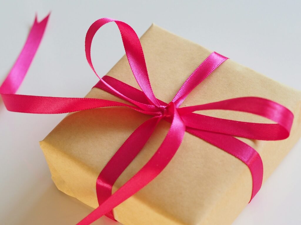 A beautifully wrapped birthday gift box sits on a table,card that reads, "Happy Birthday!" This thoughtful gift symbolizes the best gift to give wife on birthday, reflecting love and appreciation for her special day.