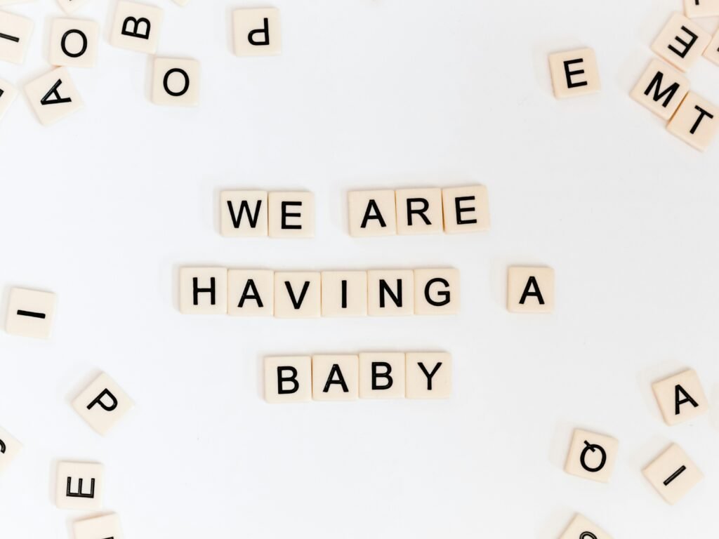 Happy couple announcing pregnancy with a baby shopping list for first-time moms, featuring essential items for newborn care